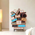 Multicolored drawer unit in a room setting with a lamp and bed.